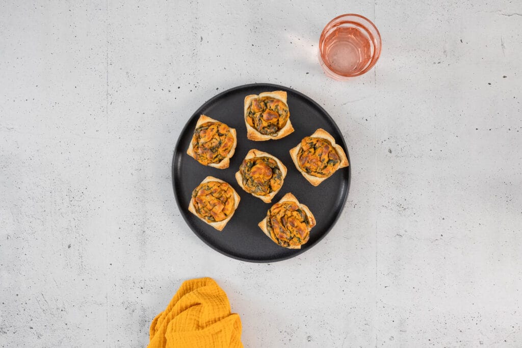 vegane Mini Quiche Muffins auf schwarzem Teller angerichtet als Apéro Fingerfood