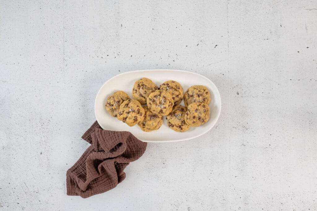 Vegane Chocolate Chip Cookies auf einer weissen Platte – chewy, weich und ohne Ei gebacken
