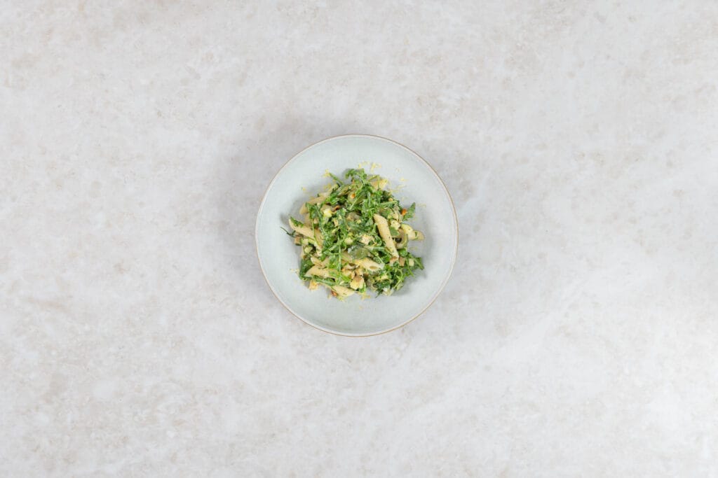 Green Goddess Pastasalat vegan auf hellem Teller, Nahaufnahme von oben