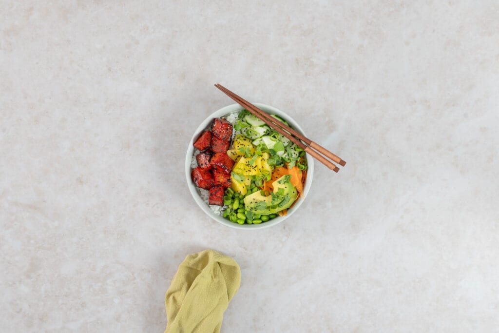 Vegane Wassermelonen-Thunfisch Poké Bowl mit Sushi-Reis, Avocado, Ananas, Gurke, Karotte und Edamame