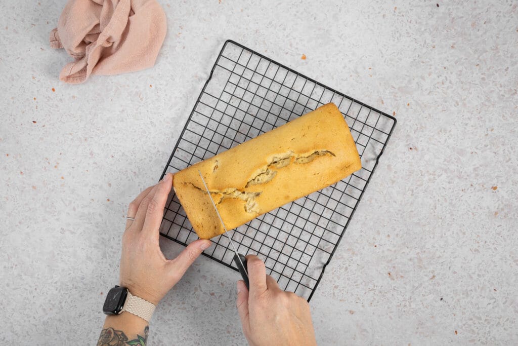 Abgekühltes veganes Fruchtsalatcake wird auf dem Gitter in Scheiben geschnitten
