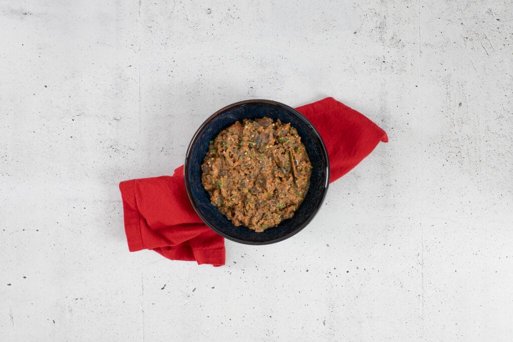 Traditioneller marokkanischer Auberginensalat Zaalouk in einer Schale auf roter Serviette